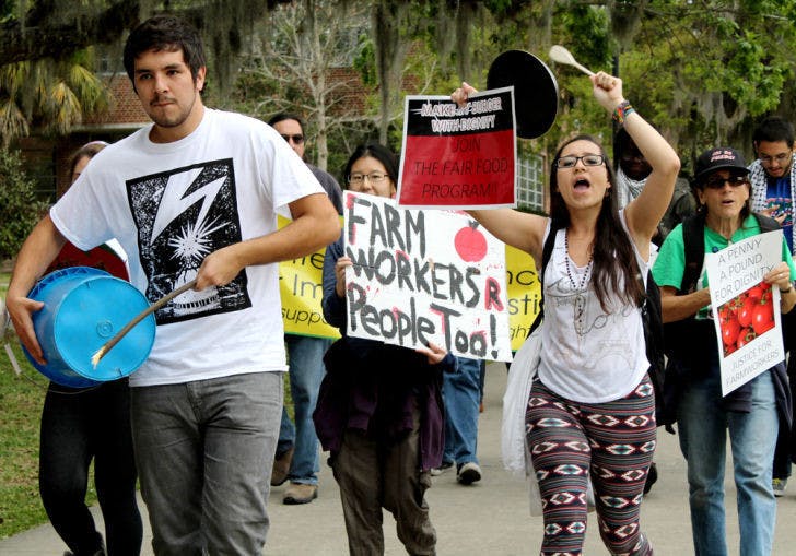Protesters march along the North Lawn Thursday demanding fair wages for Florida’s farmworkers. The group wants Wendy’s restaurants to commit to the Fair Food Program by the Coalition of Immokalee Workers.&nbsp;