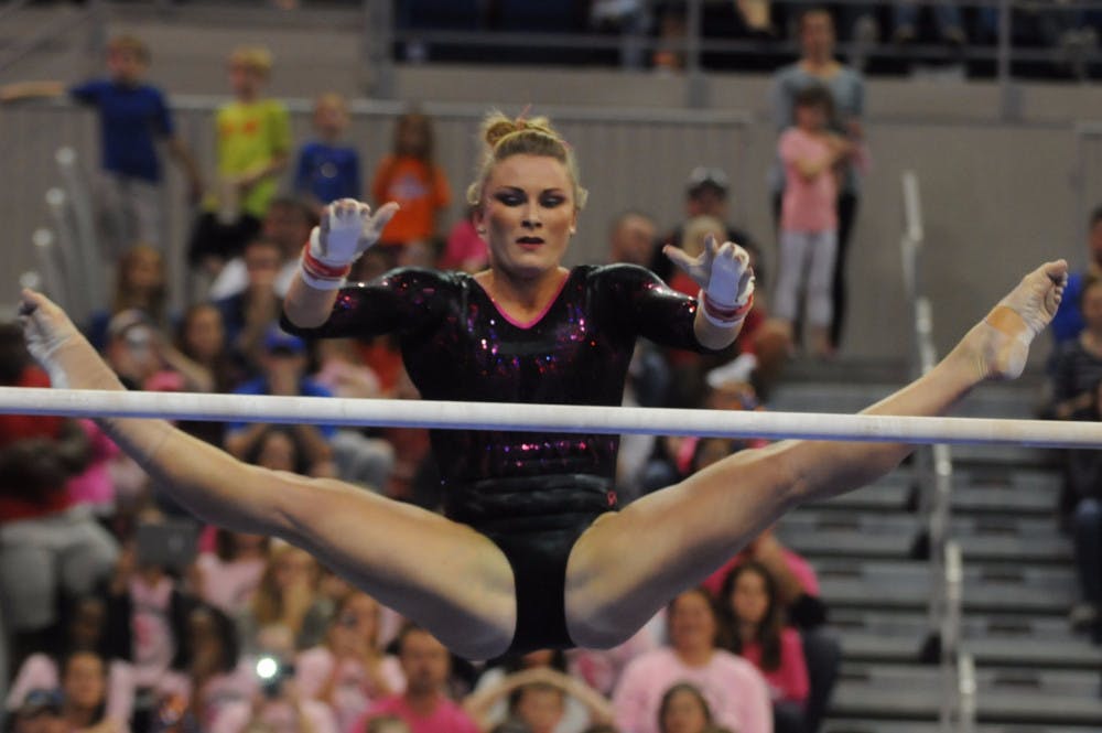 Bridget Sloan performs on the uneven parallel bars during Florida's win against Arkansas on Feb. 12, 2016, in the O'Connell Center.