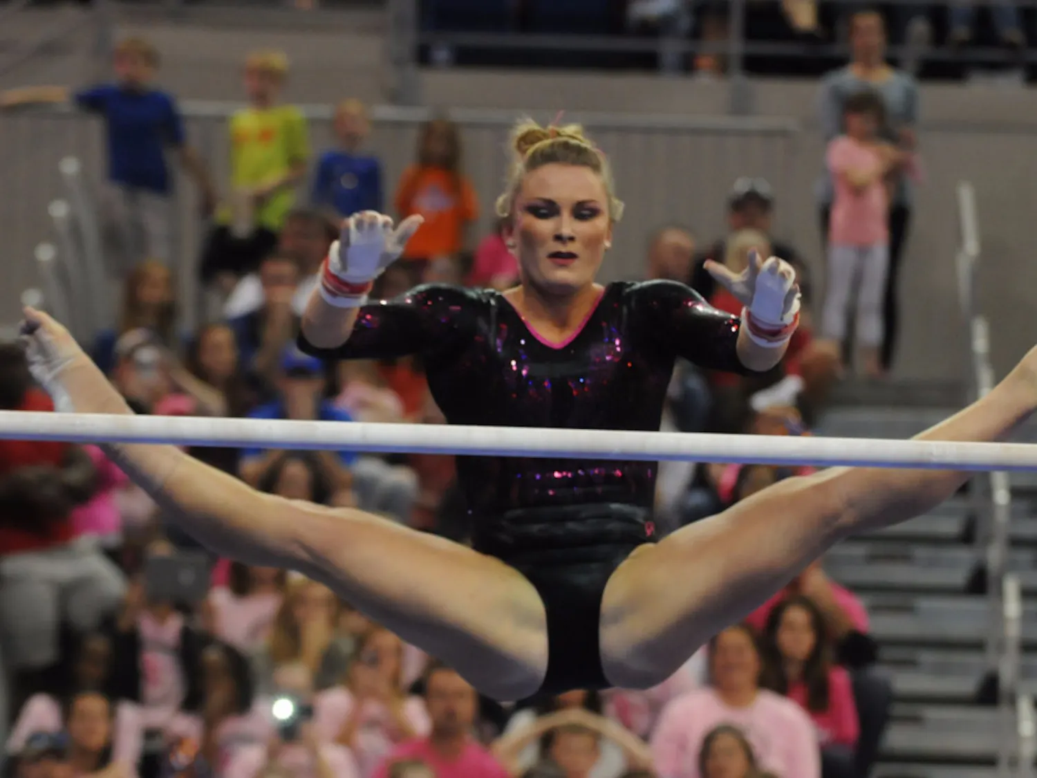 Bridget Sloan performs on the uneven parallel bars during Florida's win against Arkansas on Feb. 12, 2016, in the O'Connell Center.
