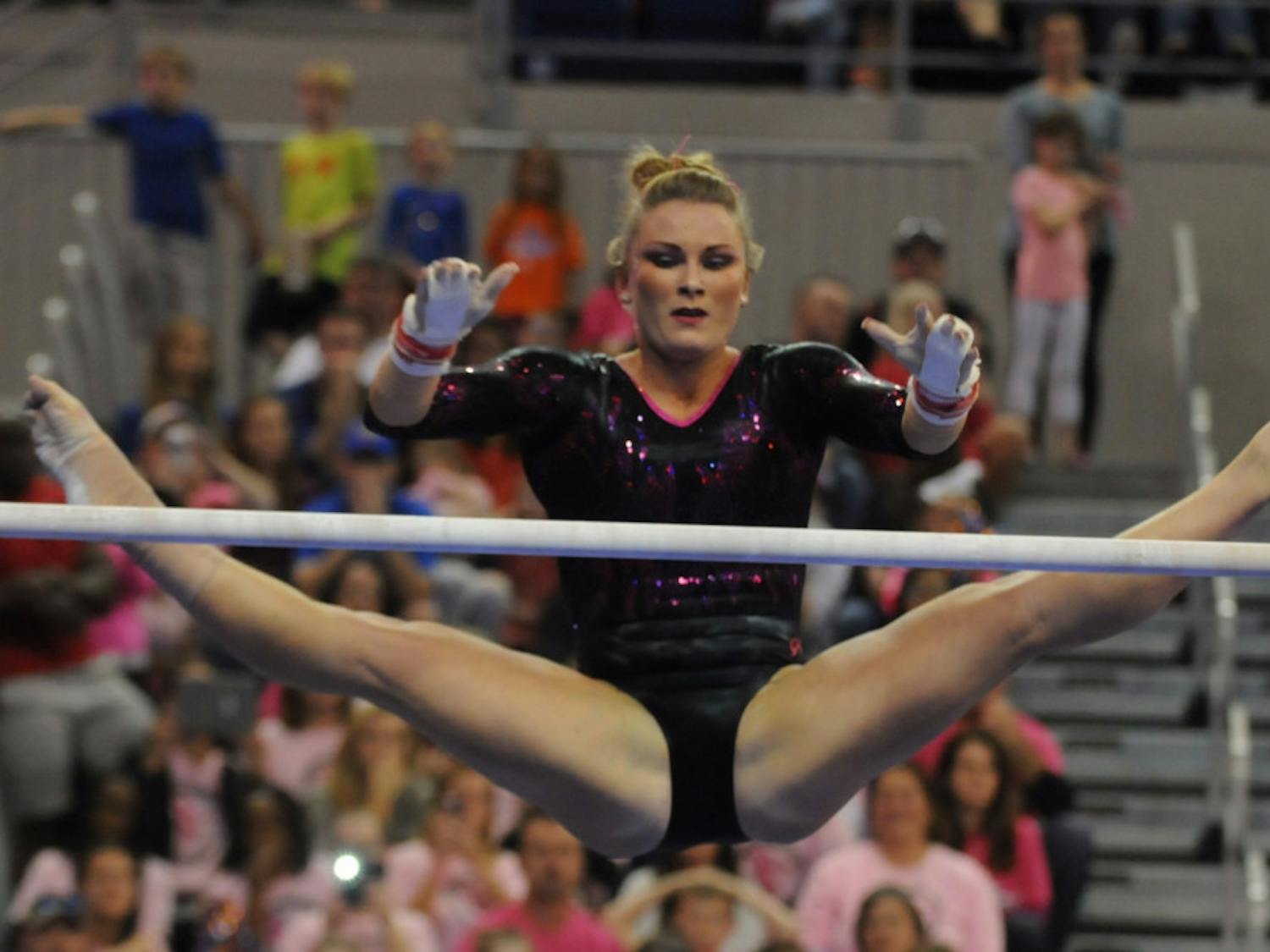 Bridget Sloan performs on the uneven parallel bars during Florida's win against Arkansas on Feb. 12, 2016, in the O'Connell Center.