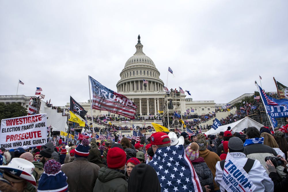 Rioters loyal to President Donald Trump rally at the U.S. Capitol in Washington on Jan. 6, 2021. Law enforcement officials say, Taylor Taranto, a man wanted for crimes related to the Jan. 6, 2021, insurrection at the U.S. Capitol has been arrested in the Washington neighborhood where former President Barack Obama lives. Taranto was seen a few blocks from the former president's home, and he fled even though he was chased by U.S. Secret Service agents. (AP Photo/Jose Luis Magana, File)