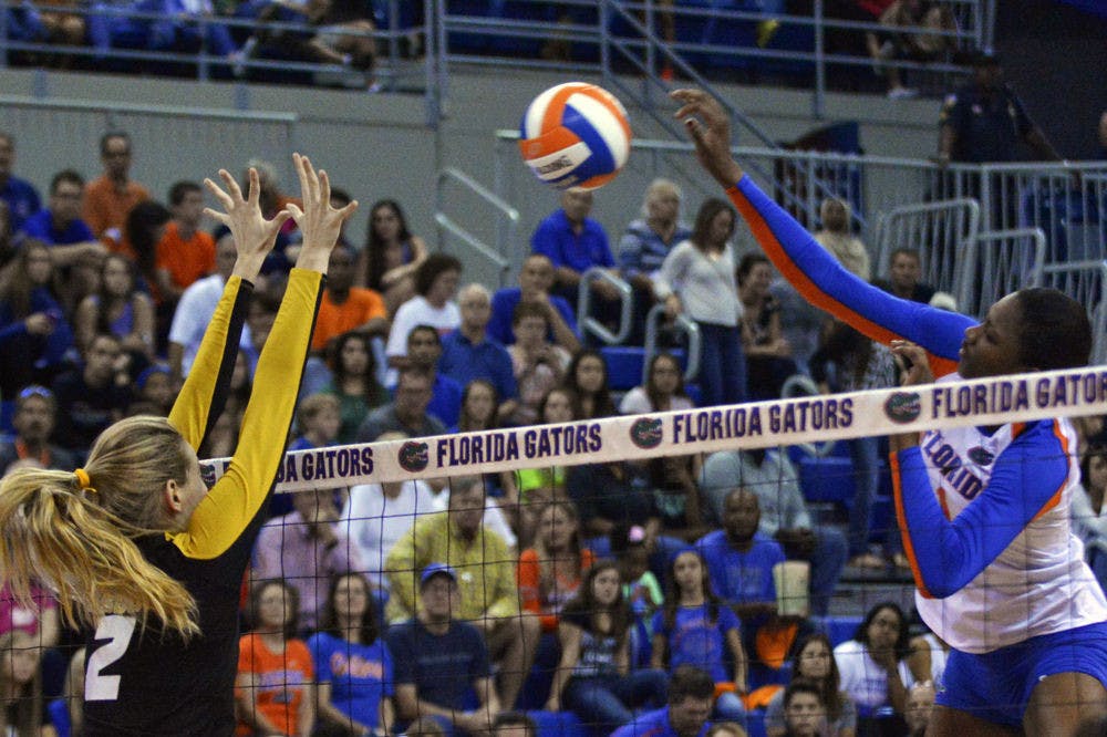 Freshman middle blocker Rhamat Alhassan swings at a ball during Florida's 3-0 win against Missouri