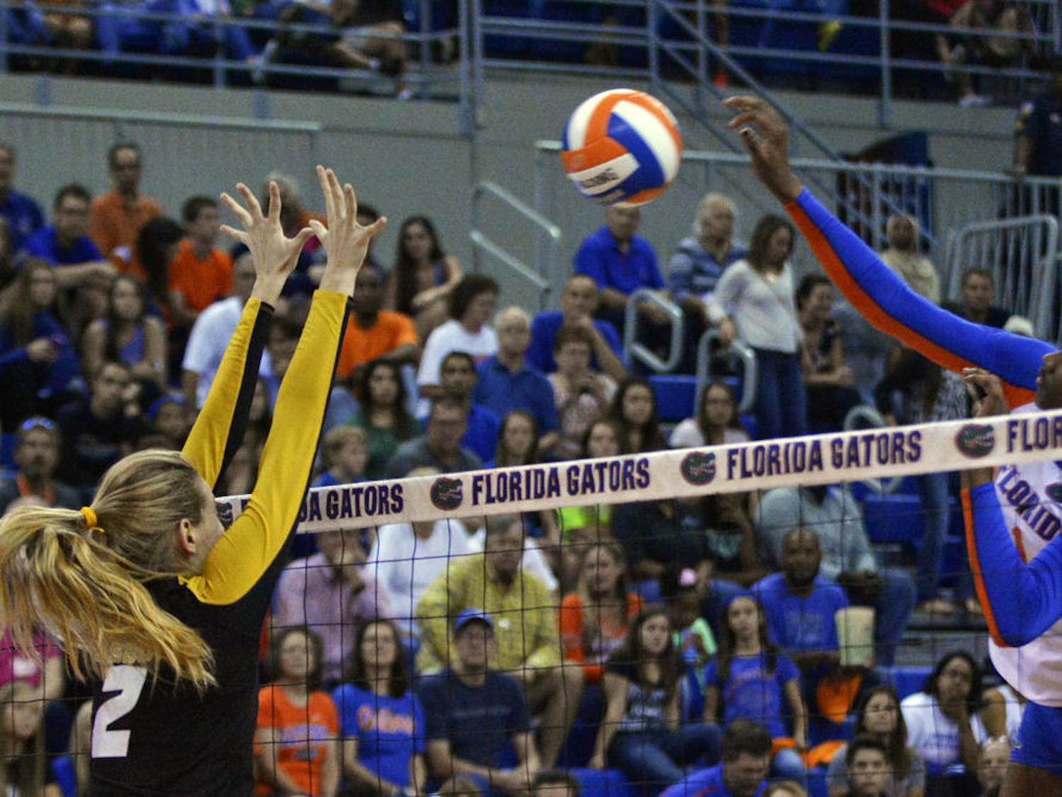 Freshman middle blocker Rhamat Alhassan swings at a ball during Florida's 3-0 win against Missouri