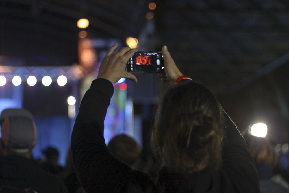 A fan takes a photo of Hot Water Music on Bo Diddley Community Plaza on Sunday night.
&nbsp;