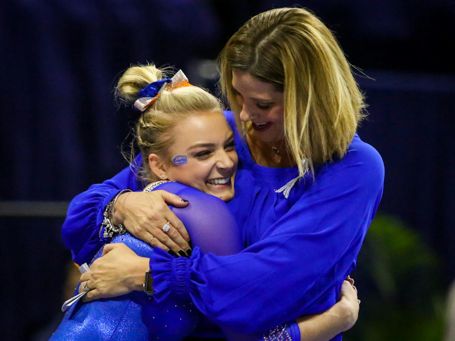 Florida coach Jenny Rowland hugs gymnast Alyssa Baumann after her beam routine during UF’s 198.15-198.125 win over Oklahoma on Jan. 26, 2018.