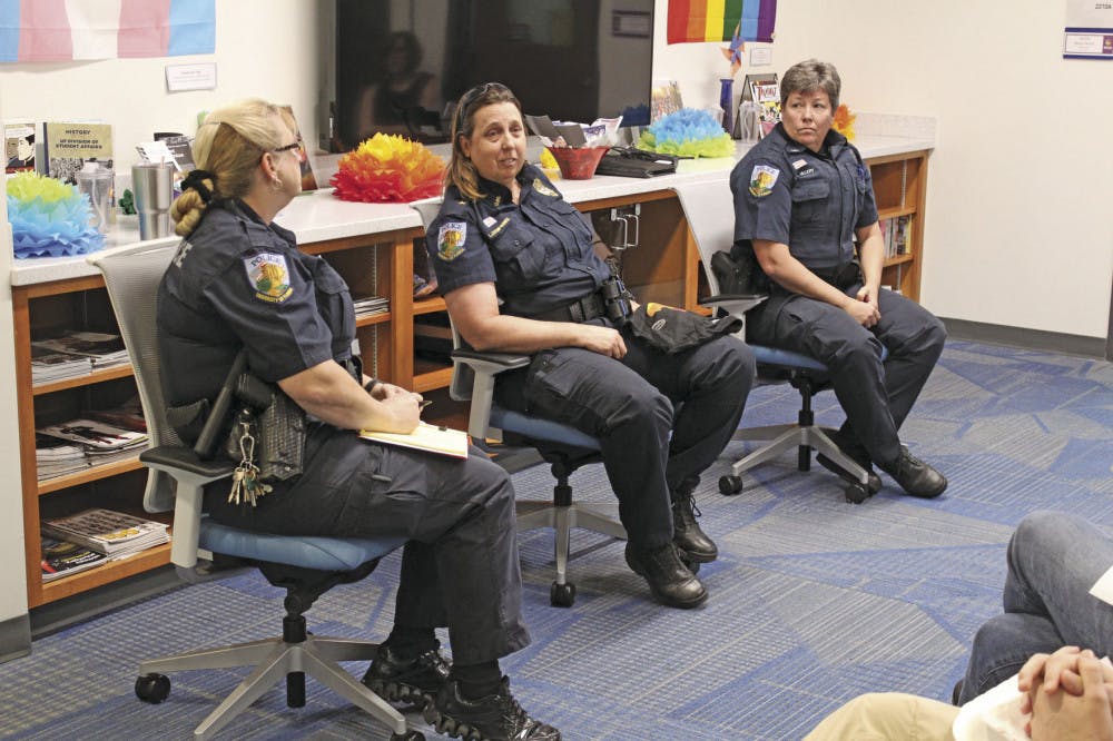 <p>Officers Susan Pratt and Diana Ullery flank Chief Linda Stump-Kurnick as she answers a question at the University Police’s town hall in UF’s Rainbow Suite on Tuesday, February 7, 2017. The officers were there to answer questions from the students, but several students attended only to disrupt the event, interrupting with phrases such as, “Lay with pigs, wake up dirty.”</p>