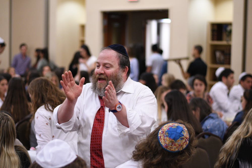 <p><span id="docs-internal-guid-2343e106-7fff-146c-3cb4-12d538d03ee0"><span>Rabbi Berl Goldman celebrates with attendees during the Lubavitch Chabad Jewish Student and Community Center’s Rosh Hashanah service Sunday night. The service commemorates the Jewish new year and is delivered in Hebrew.</span></span></p>