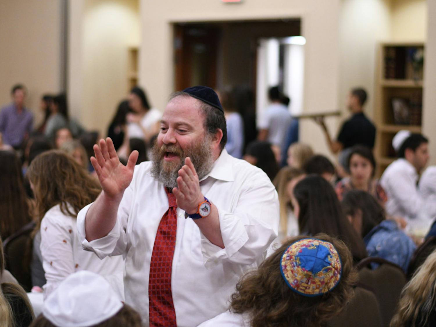 Rabbi Berl Goldman celebrates with attendees during the Lubavitch Chabad Jewish Student and Community Center’s Rosh Hashanah service Sunday night. The service commemorates the Jewish new year and is delivered in Hebrew.