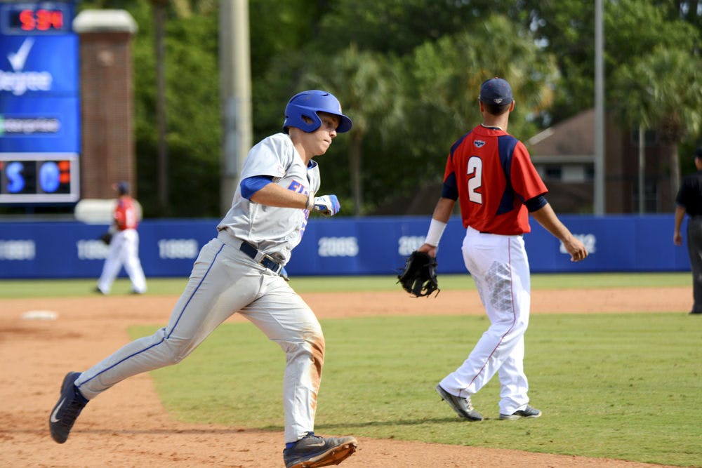 <p>JJ Schwarz rounds third base during Florida's win against Florida Atlantic in the 2015 NCAA Regionals at McKethan Stadium.</p>