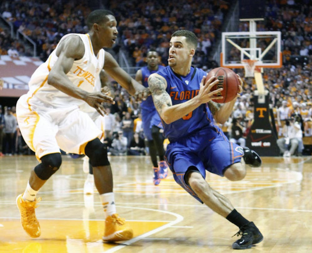 <p>Scottie Wilbekin (right) drives against Tennessee guard Josh Richardson during No. 3 Florida’s 67-58 win against Tennessee on Tuesday night in Knoxville, Tenn. Wilbekin led the Gators with a career-high 21 points.</p>