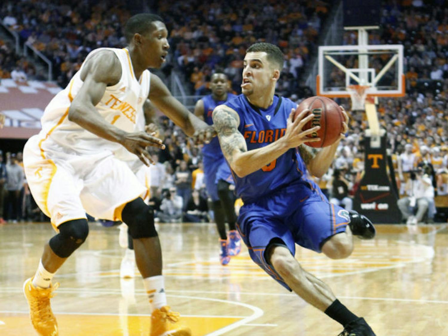 Scottie Wilbekin (right) drives against Tennessee guard Josh Richardson during No. 3 Florida’s 67-58 win against Tennessee on Tuesday night in Knoxville, Tenn. Wilbekin led the Gators with a career-high 21 points.