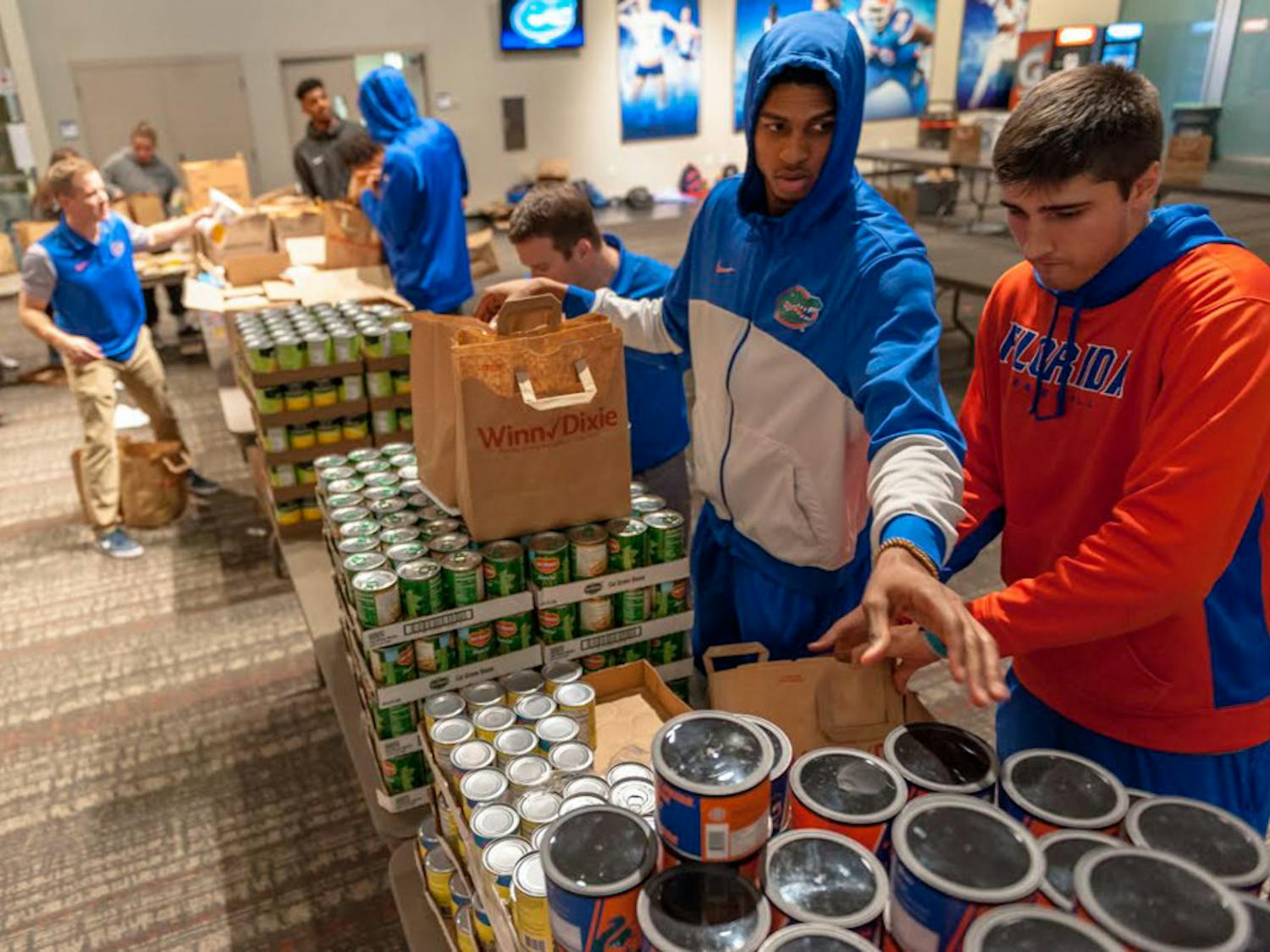 The University Athletic Association works with Grace Marketplace and Catholic Charities to find the homeless and families in need. On Monday, UF athletes filled 1,200 Winn-Dixie bags with Thanksgiving food — enough to feed 600 local families.