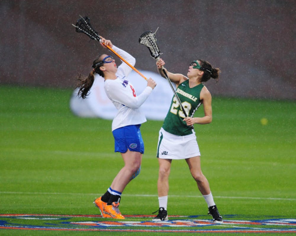 <p>Shannon Gilroy fights for the ball during Florida’s 21-5 win against Jacksonville on Feb. 12 at Donald R. Dizney Stadium. Gilroy leads the Gators with 35 goals this season.</p>