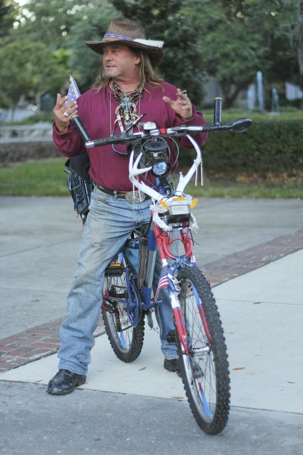 Chopper Dave, 51, pauses during his bike ride downtown Monday afternoon. “I MacGyver everything,” Dave said, adding that he “chopped out” his bike in only a week or so.