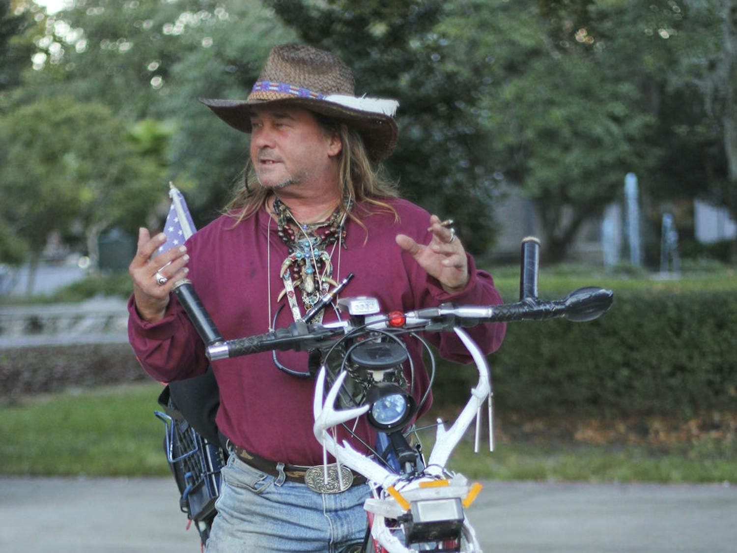 Chopper Dave, 51, pauses during his bike ride downtown Monday afternoon. “I MacGyver everything,” Dave said, adding that he “chopped out” his bike in only a week or so.