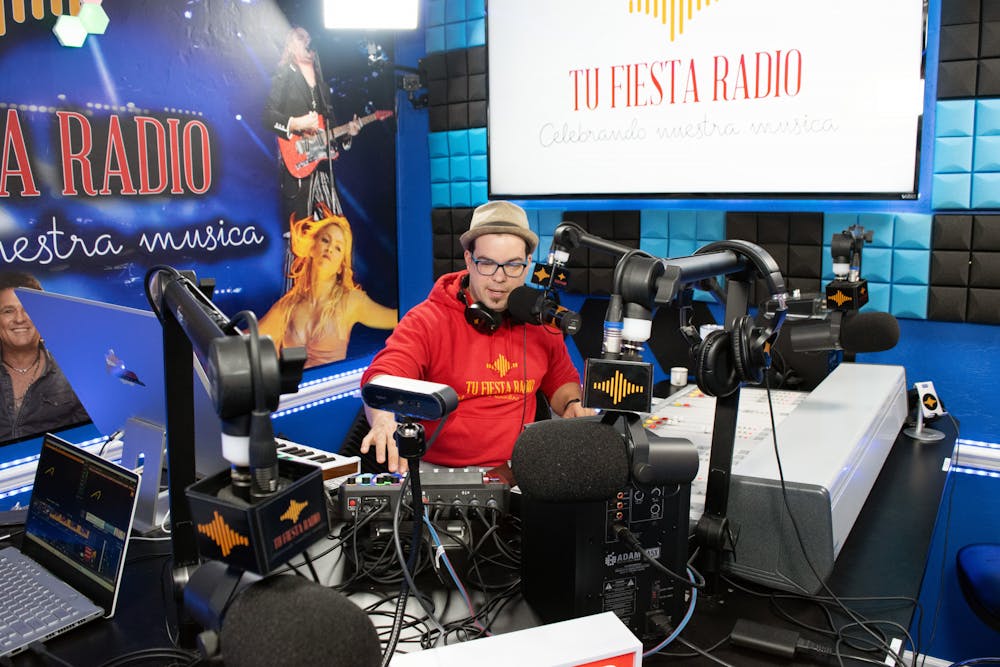 <p>Radio host Elio Piedra announces the next song to be played to listeners of Tu Fiesta Radio Thursday, March 2, 2023. </p>