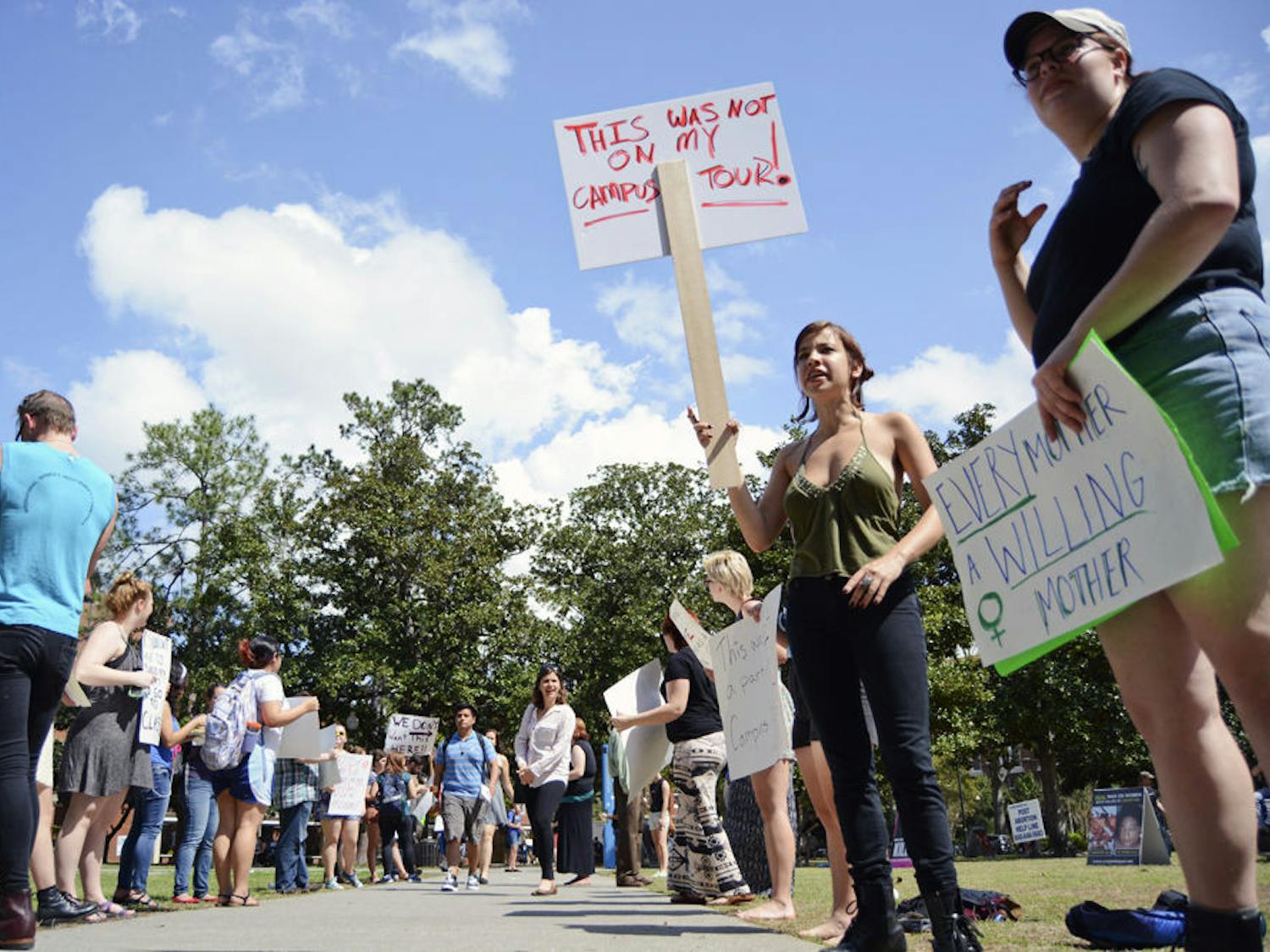 Hannah Gutman, a 22-year-old Santa Fe theater senior, holds a sign reading “This was not on my campus tour,” at an abortion rights protest held on the Plaza of the Americas on Wednesday afternoon. Dozens of people gathered on the plaza to protest the graphic abortion imagery shown by Created Equal, an Ohio-based organization.