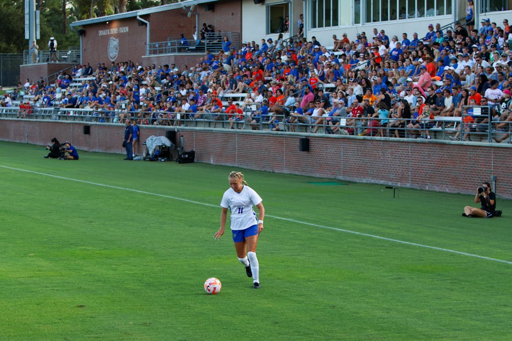 <p>Redshirt sophomore midfielder Sophie White dribbles the ball up the field in the Gators&#x27; 8-0 win against the Stetson Hatters Sunday, Aug. 27, 2023.﻿</p>
