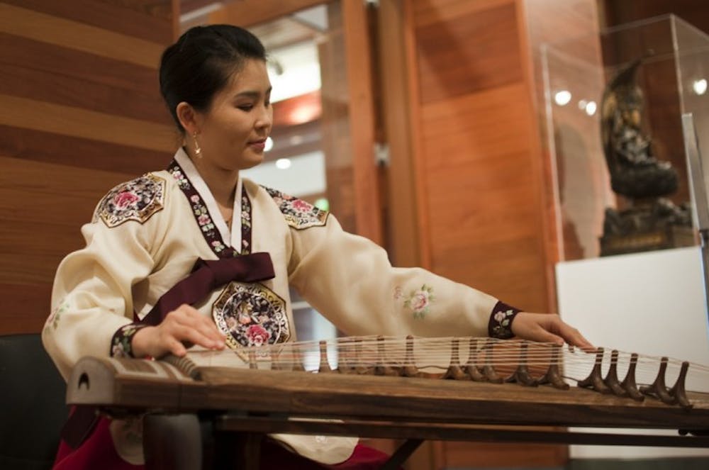 <p>Sangmi Kang plays the Gayageum at the grand opening of the David A. Cofrin Asian Art Wing held at the Samuel P. Harn Museum of Art on Saturday.</p>