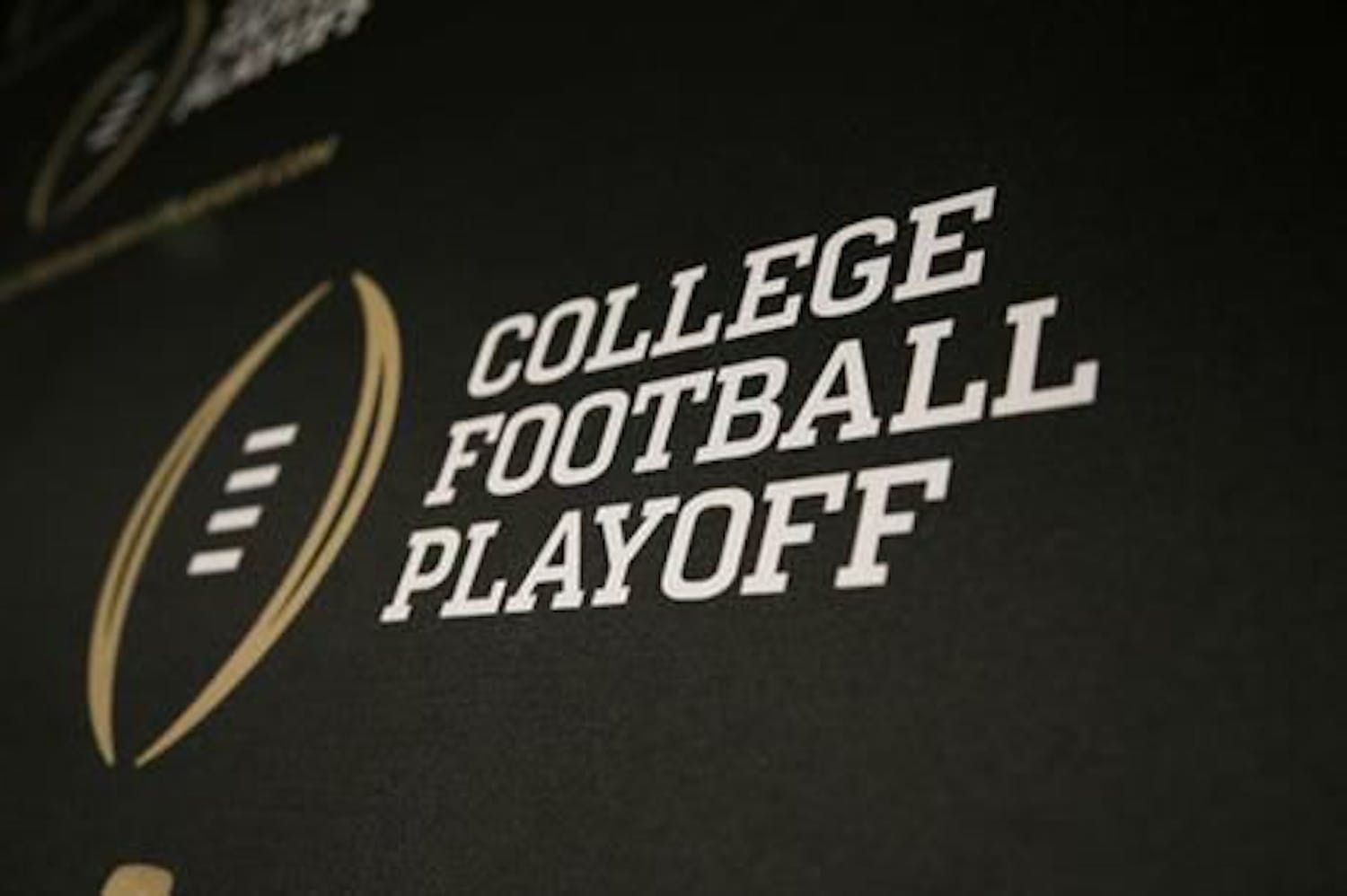 This Oct. 16, 2013 photo shows the College Football Playoff logo printed across a backdrop used during a news conference in Irving, Texas. (AP Photo/Tony Gutierrez)