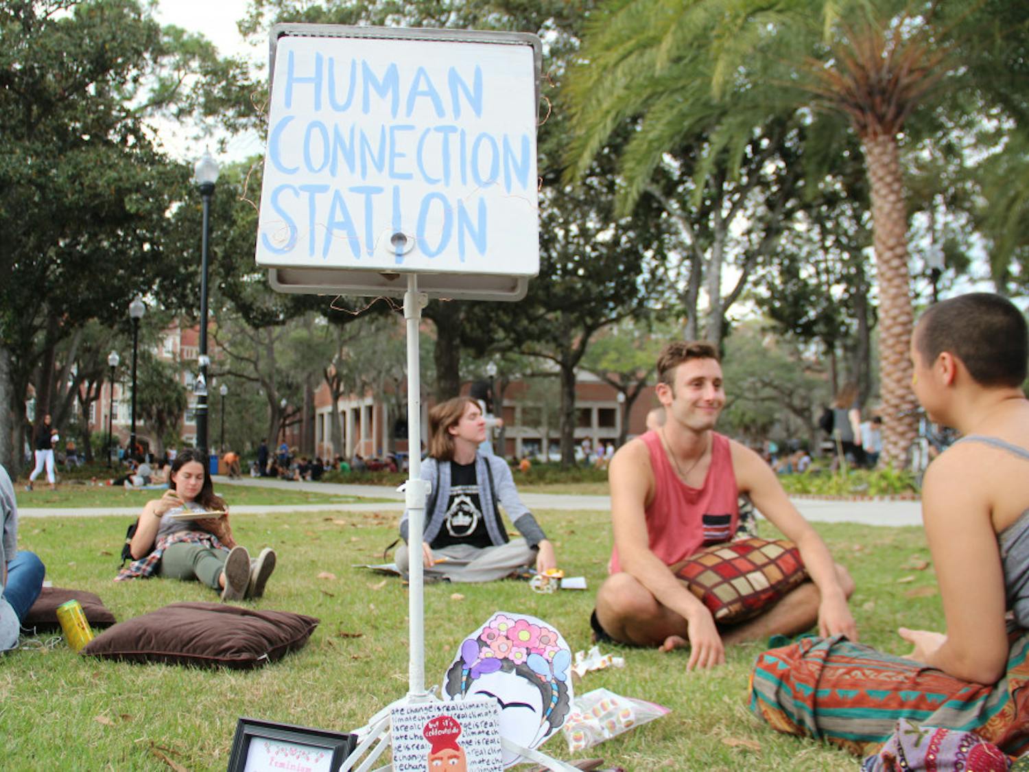 Participants started into each other’s eyes at the Human Connection Station, a public art piece displayed on Plaza of the Americas on Wednesday afternoon. The piece was displayed on the one year anniversary of the 2016 presidential election.