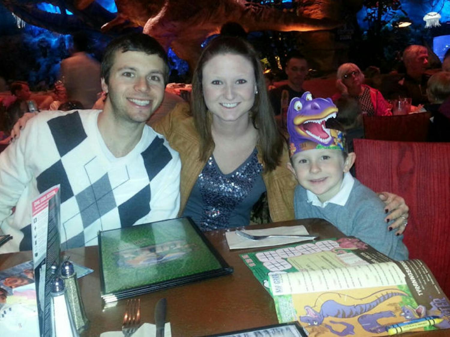 Brian Fryburg, Lauren Furgason and Todd Miller eat at the T-Rex Cafe in Orlando’s Downtown Disney. Todd went into cardiac arrest last month and has been in the hospital since.