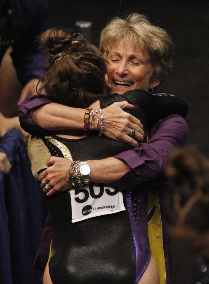 LSU coach "DD" Breaux (right) hugs Sydney Ewing after Ewing's balance beam routine during the NCAA college women's gymnastics championships on April 18, 2014, in Birmingham, Alabama.
&nbsp;