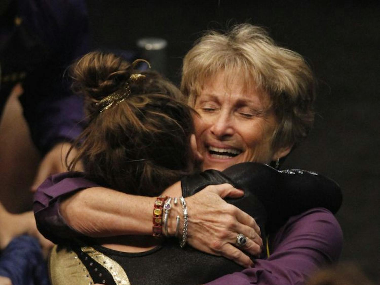 LSU coach "DD" Breaux (right) hugs Sydney Ewing after Ewing's balance beam routine during the NCAA college women's gymnastics championships on April 18, 2014, in Birmingham, Alabama.
&nbsp;