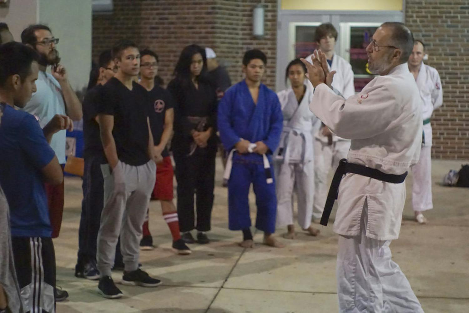 John Kammer, 66, teaches students the basics of judo Oct. 13, 2015, at Ben Hill Griffin Stadium during Asian Kaleidoscope Month’s Throwdown event. Kammer has been teaching judo for 43 years. He instructed students on basic techniques of striking, clinch-fighting and breaking grips.