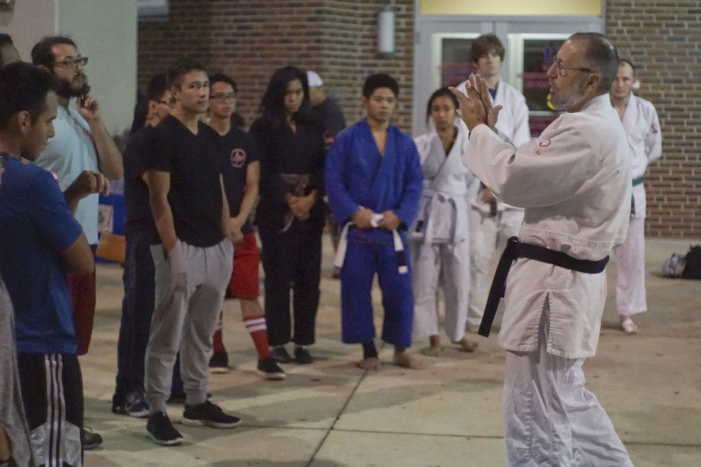 <p>John Kammer, 66, teaches students the basics of judo Oct. 13, 2015, at Ben Hill Griffin Stadium during Asian Kaleidoscope Month’s Throwdown event. Kammer has been teaching judo for 43 years. He instructed students on basic techniques of striking, clinch-fighting and breaking grips.</p>