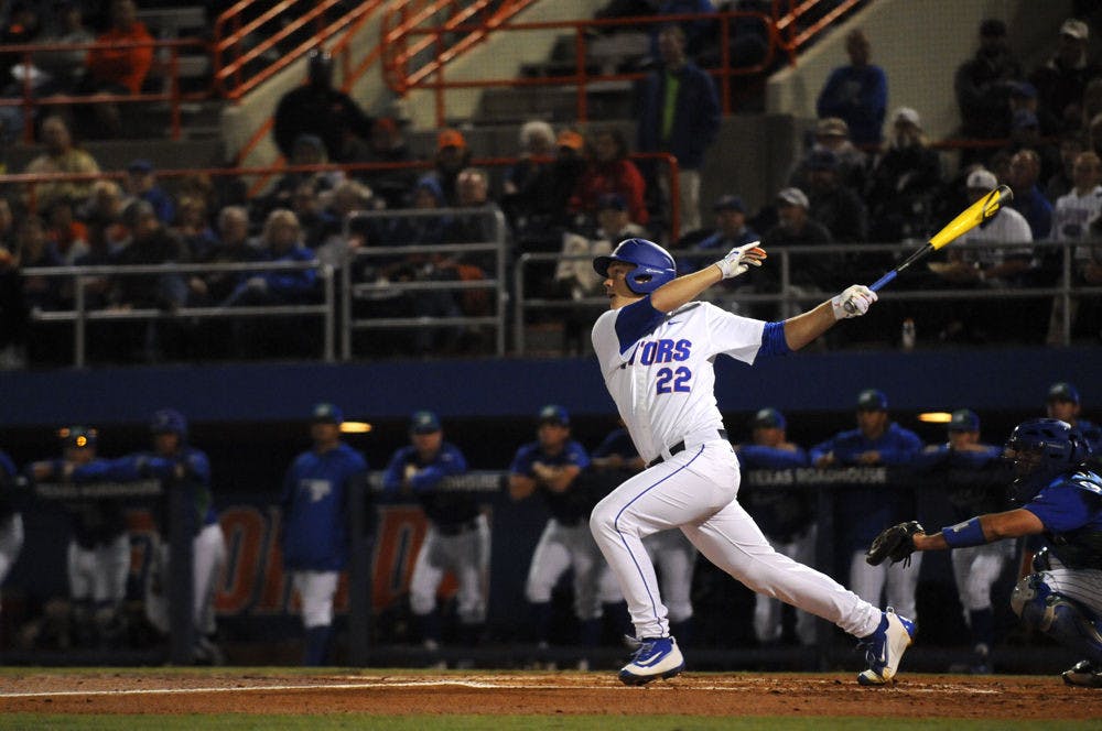 JJ Schwarz follows through on a swing during Florida's 4-2 win against Florida Gulf Coast on Feb. 19, 2016, at McKethan Stadium.