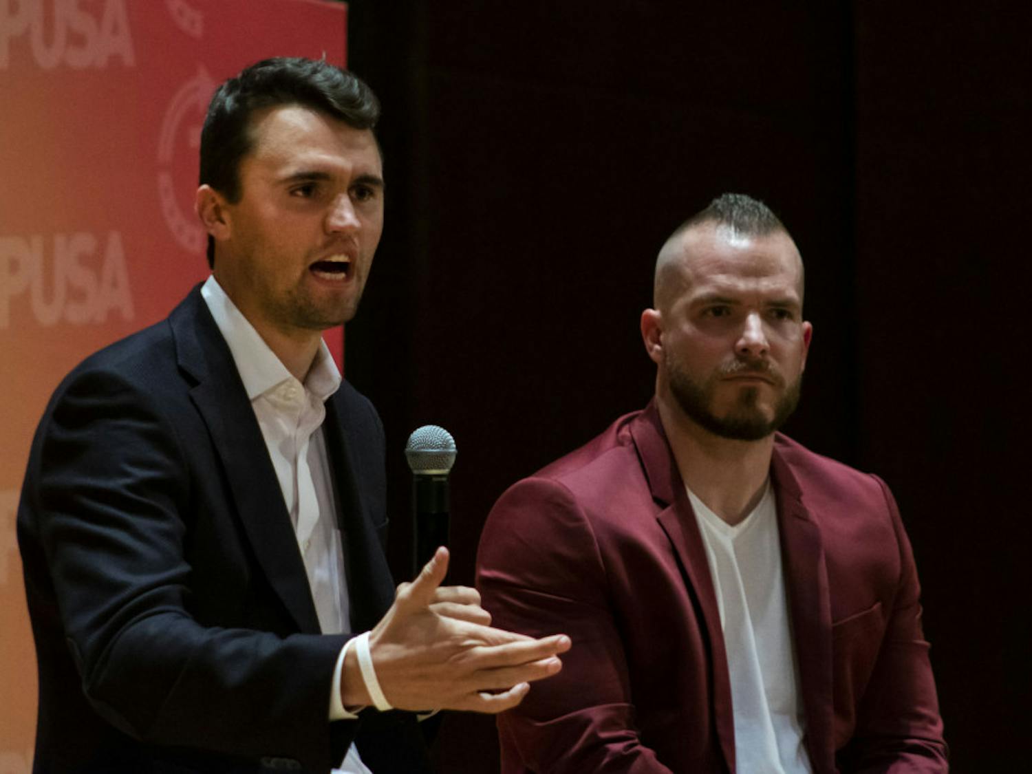 Charlie Kirk, leader of Turning Point USA, and Graham Allen, political speaker, answer questions from an audience in University Auditorium. Kirk was one of several conservative figures to criticize UF for suspending three student groups for violating university COVID-19 policies.