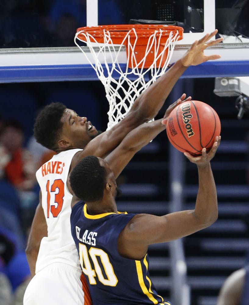 Florida forward Kevarrius Hayes (13) blocks a shot by East Tennessee State forward Tevin Glass (40) during the second half of the first round of the NCAA college basketball tournament, Thursday, March 16, 2017 in Orlando, Fla. Florida defeated ETSU 80-65. (AP Photo/Wilfredo Lee)