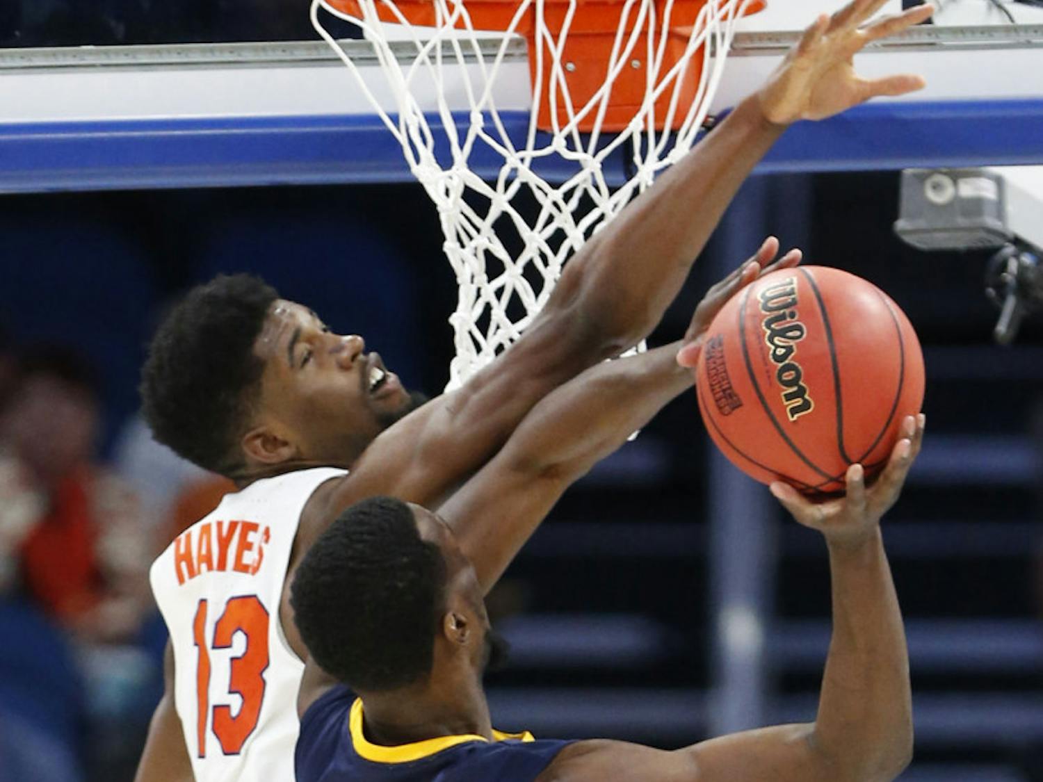 Florida forward Kevarrius Hayes (13) blocks a shot by East Tennessee State forward Tevin Glass (40) during the second half of the first round of the NCAA college basketball tournament, Thursday, March 16, 2017 in Orlando, Fla. Florida defeated ETSU 80-65. (AP Photo/Wilfredo Lee)
