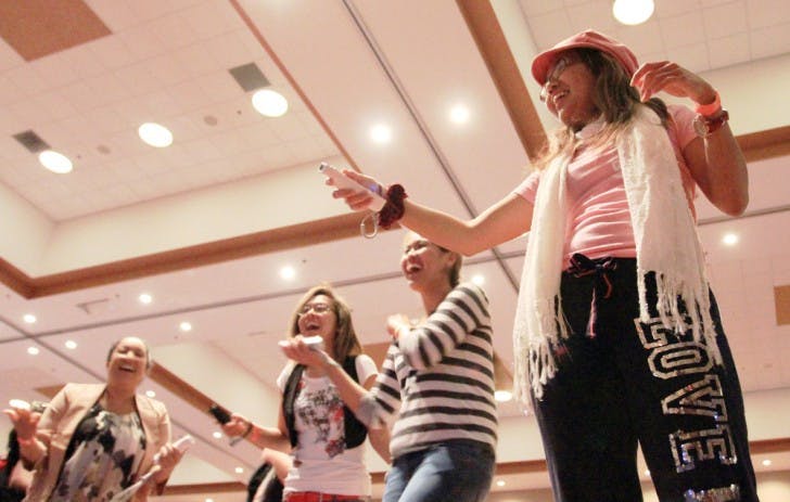 Sonia Dela Cruz, right, a 21-year-old microbiology junior, plays a dance video game during GatorLAN in the Reitz Union Grand Ballroom in November of 2012.