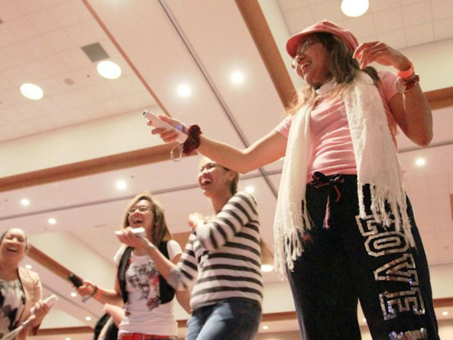 Sonia Dela Cruz, right, a 21-year-old microbiology junior, plays a dance video game during GatorLAN in the Reitz Union Grand Ballroom in November of 2012.