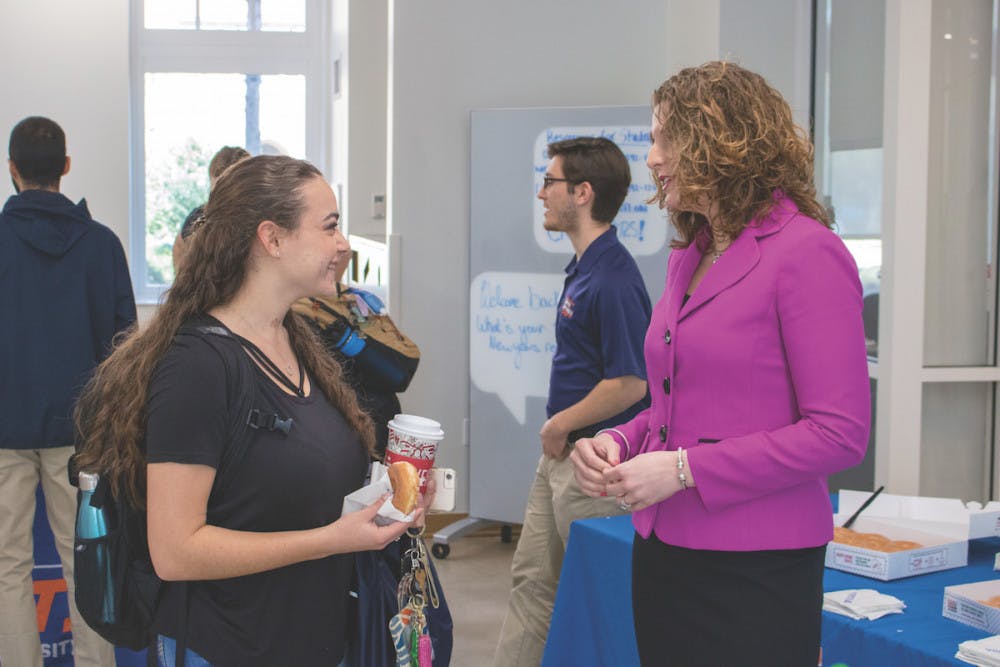 Christina Sedaros, a UF statistics freshman, talks with Dr. Heather White, the Associate Vice President for Student Affairs and Dean of Students, at the Donuts with the Dean event in Newell Hall on Tuesday. Sedaros said she goes to Newell every day. 
