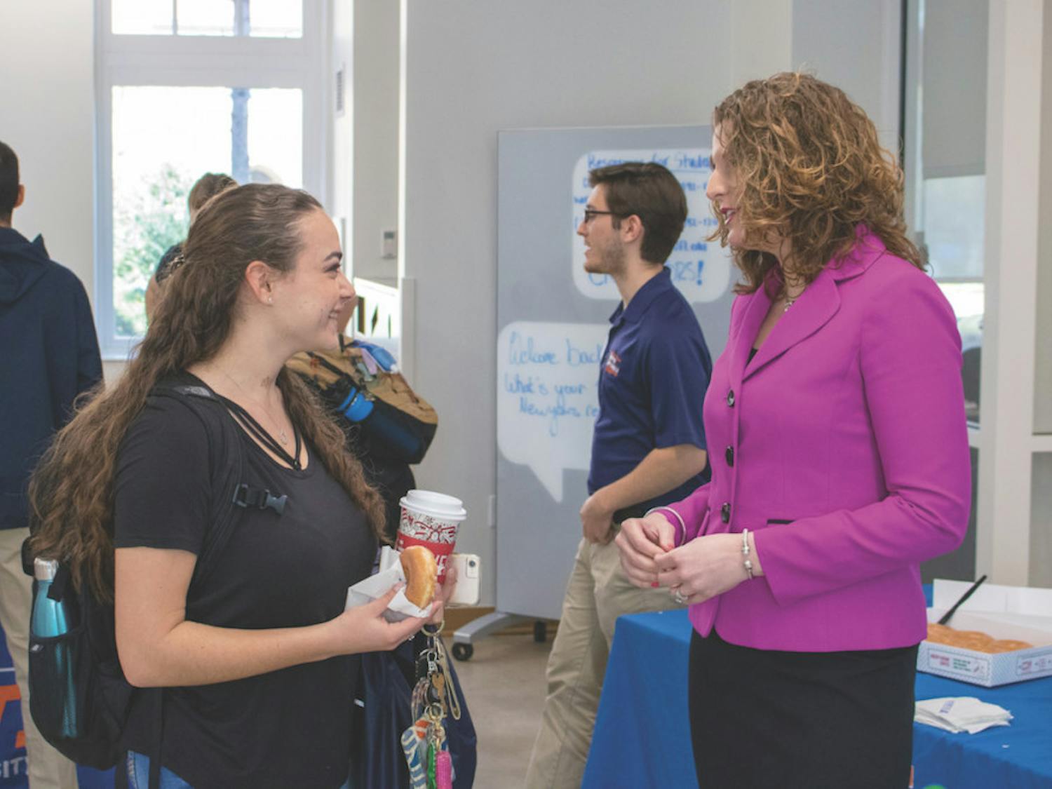 Christina Sedaros, a UF statistics freshman, talks with Dr. Heather White, the Associate Vice President for Student Affairs and Dean of Students, at the Donuts with the Dean event in Newell Hall on Tuesday. Sedaros said she goes to Newell every day.