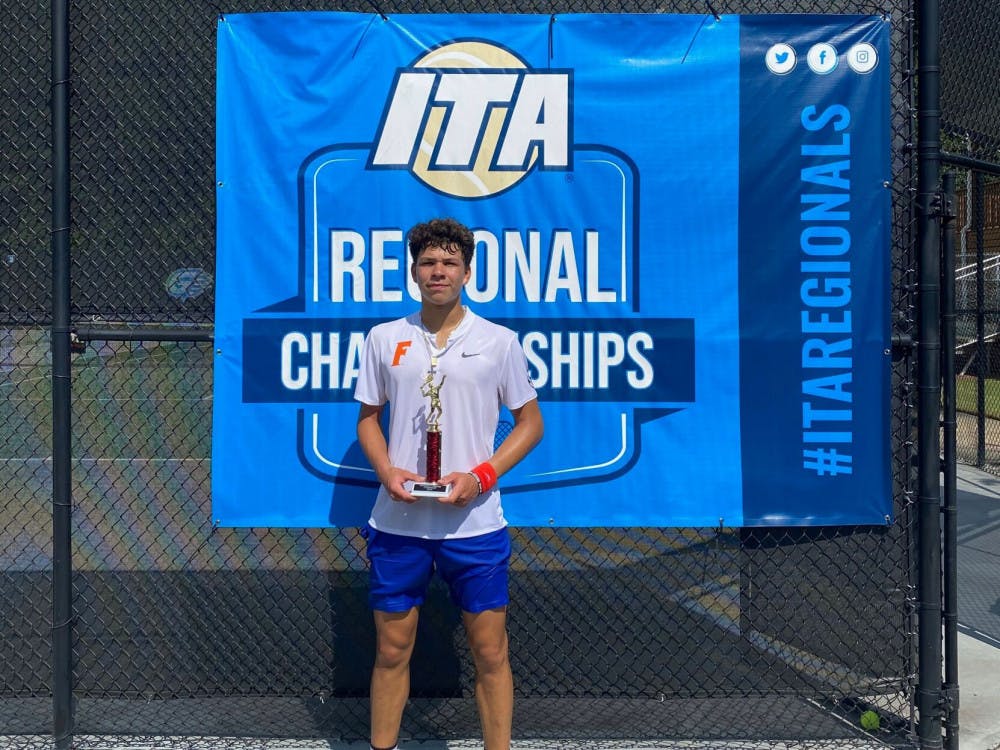 <p>Freshman Ben Shelton stands with the trophy he earned after winning the ITA Fall Circuit&nbsp;<span id="docs-internal-guid-b5cf366e-7fff-64e2-ee4f-e854f72d5620"><span>Presented by Gwinnett Tennis.</span></span></p>