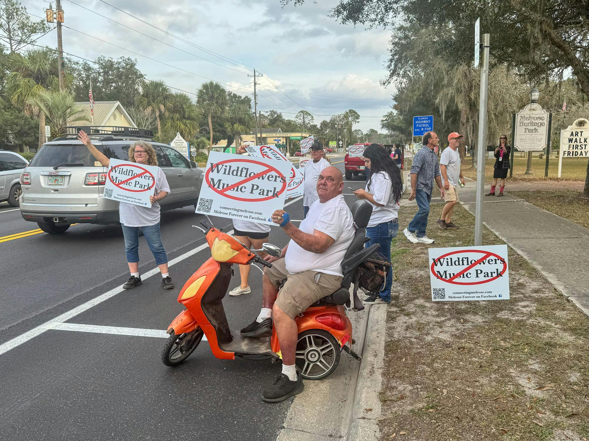 A man sits on a scooter protesting against the creation of Wildflowers Music Park in Melrose, Fla., Thursday, Jan. 8, 2026.