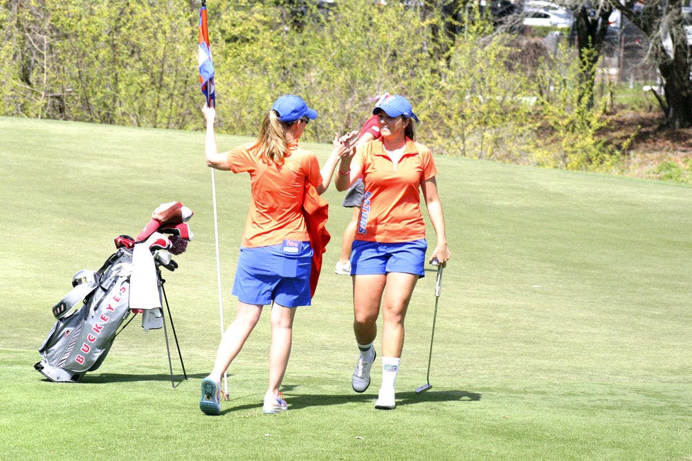 Karolina Vlckova (right) celebrates with coach Emily Glaser during the 2015 SunTrust Gator Invitational at UF's Mark Bostick Golf Course.