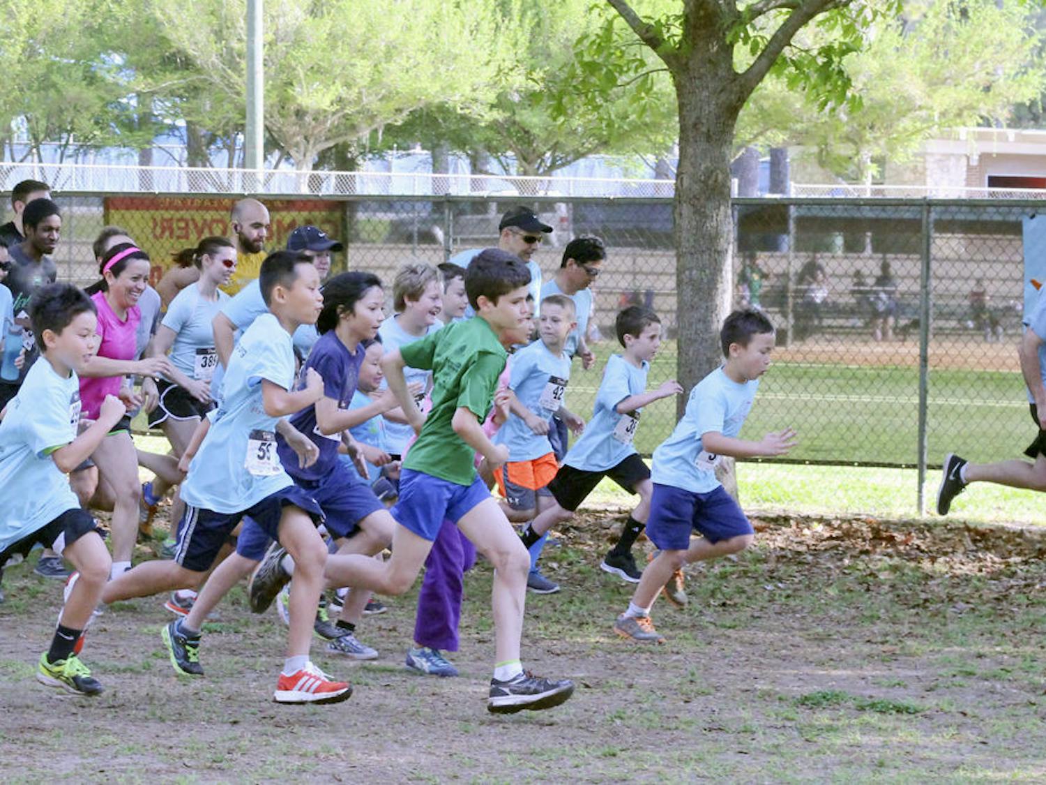 Talbot Elementary School students and Gainesville community members begin running during Joey’s Run Saturday morning at Westside Recreation Center. The run was hosted by Joey’s Wings Foundation in memory of 10-year-old Joey Xu, who passed away from a rare form of kidney cancer in November.