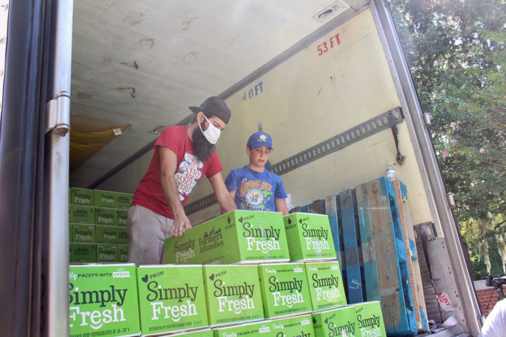 Volunteers help unload pallets full of food boxes. The food was received from the Farmers to Families Food Box initiative under the USDA, part of the Families First Coronavirus Response Act, and helps get free, fresh and local food on people’s tables. They had 750 boxes of fruits and vegetables to give away.&nbsp;
&nbsp;