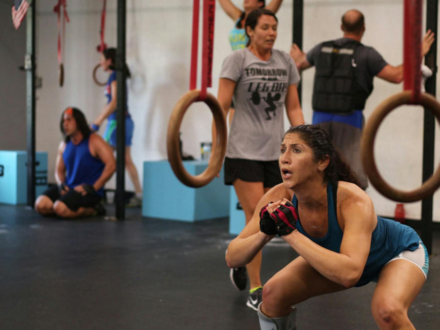 High school teacher Katherine Martinez-Malo, 41, squats 300 times at B3 Gym while attempting the Murph Challenge on Memorial Day. She was nervous about getting hurt because of the boot on her right foot, but she said she wanted to overcome whatever challenge was put in front of her for the exhilarating feeling that she finished.