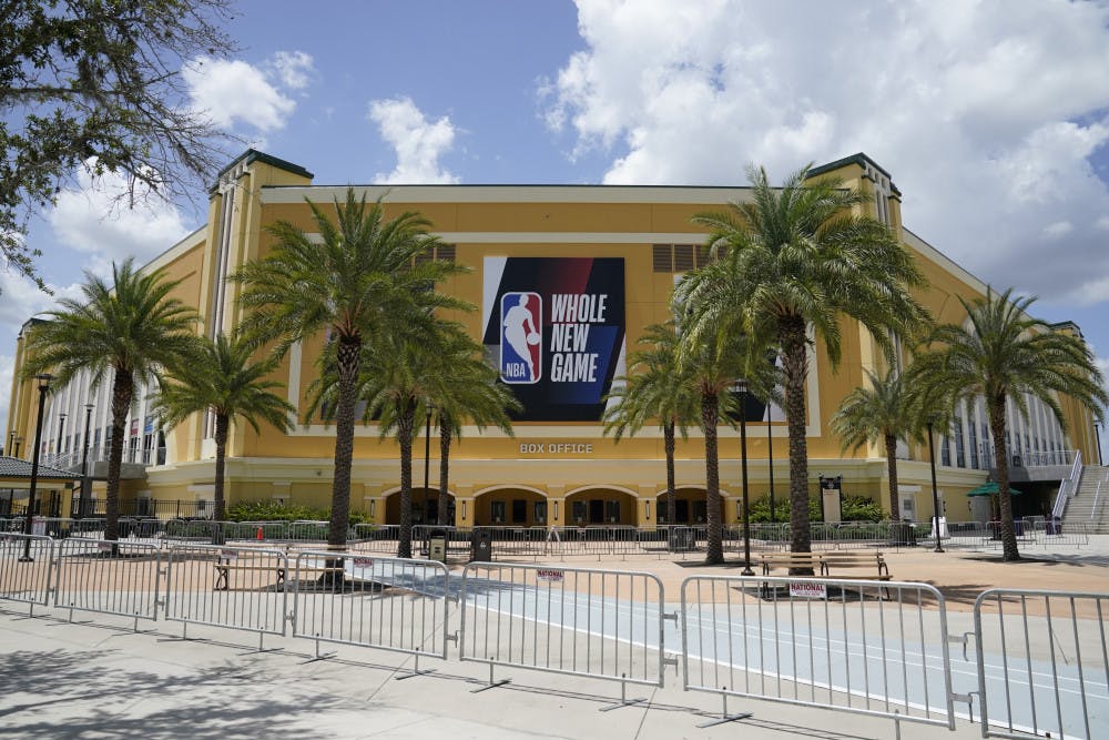 <p>An NBA sign is posted on a basketball arena at ESPN Wide World of Sports Complex Wednesday, July 29, 2020, in Orlando, Fla. NBA games will resume Thursday. (AP Photo/Ashley Landis)</p>