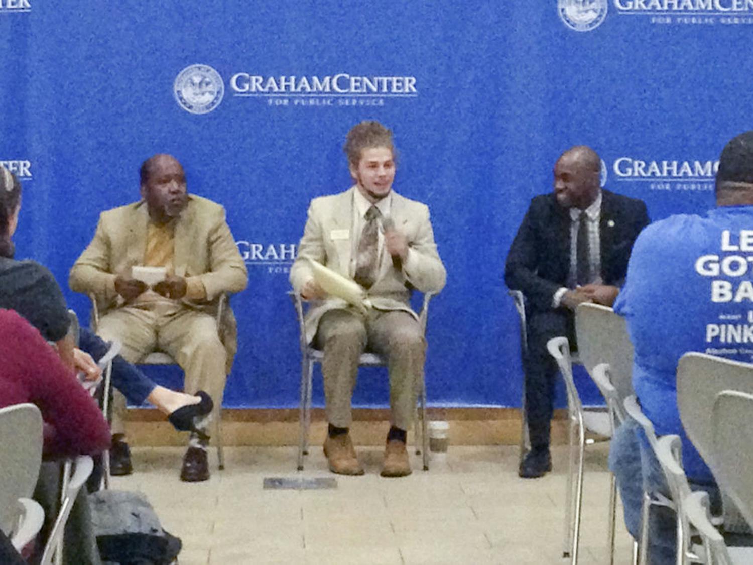 From left: Scherwin Henry, Lucas Jewell and Chris Weaver, all candidates for city commissioner for District 1, speak to an audience at an open forum event hosted by UF College Democrats in Pugh Hall on Friday night.