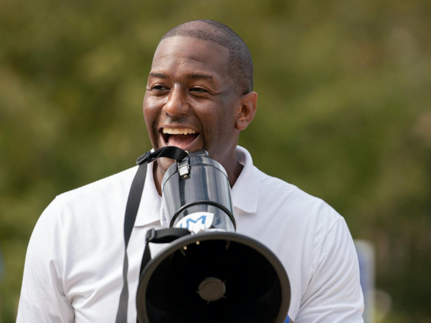 Mayor of Tallahassee and gubernatorial candidate Andrew Gillum laughs while speaking at a rally on UF's campus Friday afternoon. During the event, hosted by the Andrew Gillum campaign, Gillum walked with students to the polls.