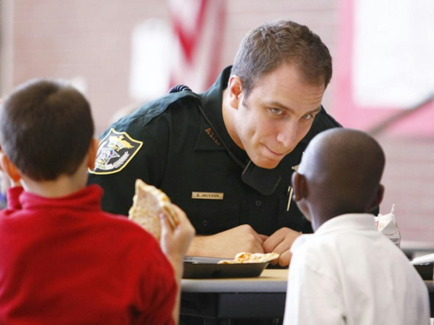 Dept. Jackson of the Alachua County Sherifs Office interacts with students at lunch on Friday at the Meadowbrook Elementary cafeteria during his second day of being stationed at the school.