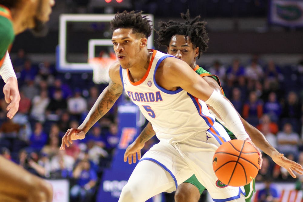 Junior guard Will Richard drives with the ball in the Gators' 89-68 win against the Florida A&M Rattlers on Tuesday, Nov. 14, 2023.