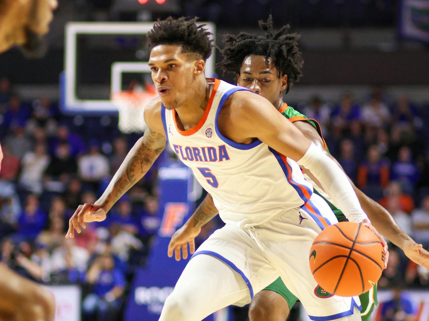 Junior guard Will Richard drives with the ball in the Gators' 89-68 win against the Florida A&M Rattlers on Tuesday, Nov. 14, 2023.